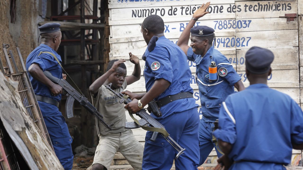 A young boy tries to cover himself as police officers beat him at an anti-government demonstration in Bujumbura, Burundi, on Tuesday, May 26. Police fired shots to disperse people <a href="http://www.cnn.com/2015/05/14/world/gallery/burundi-unrest/index.html" target="_blank">protesting against President Pierre Nkurunziza</a> and his bid for a third term.