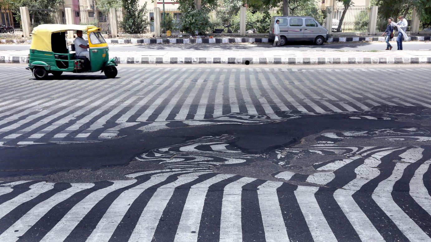 Road markings appear distorted as asphalt starts to melt because of the high temperature in New Delhi on Wednesday, May 27. <a href="http://www.cnn.com/2015/05/26/world/gallery/india-deadly-heat-wave/index.html" target="_blank">A blistering heat wave</a> has killed more than 1,300 people in India.