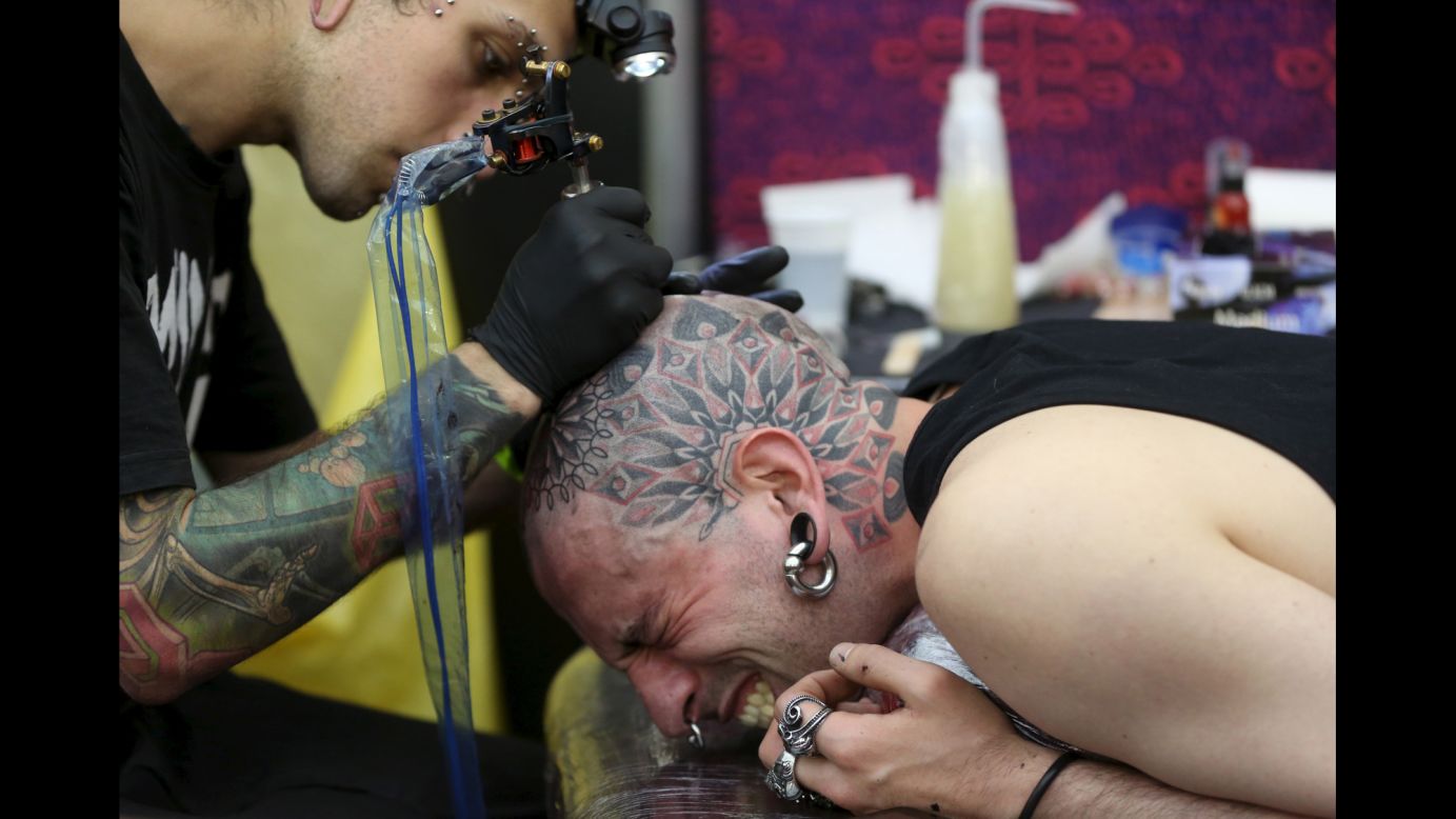 A man in London has his head tattooed during the Great British Tattoo Show on Saturday, May 23.