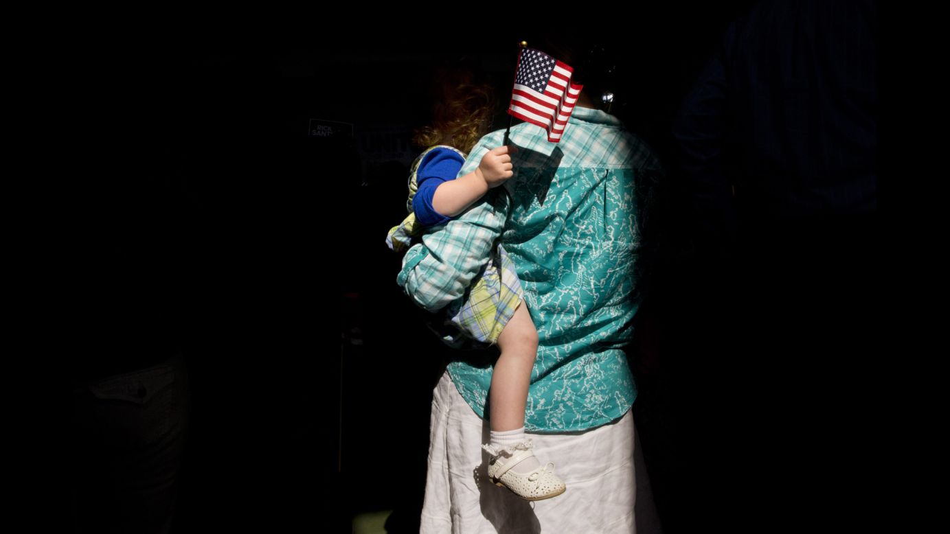 A woman holds her child in Cabot, Pennsylvania, as they wait for the arrival of former U.S. Sen. Rick Santorum on Wednesday, May 27. <a href="http://www.cnn.com/2015/05/27/politics/rick-santorum-2016-presidential-announcement/index.html" target="_blank">Santorum announced</a> that he would once again seek the Republican Party's nomination for President.