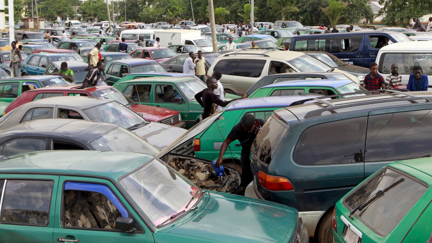 A man works on his car's engine as motorists gather at a gas station in Abuja, Nigeria, on Monday, May 25. On that day, the nation's petroleum and natural gas association <a href="http://www.cnn.com/2015/05/25/world/nigeria-shutdown-petrol-subsidies/index.html" target="_blank">suspended a strike</a> that had brought much of the country to a standstill just days before the inauguration of a new President.