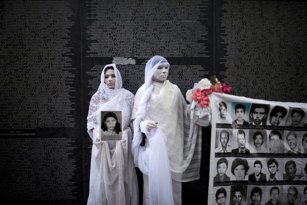 Performers in San Salvador, El Salvador, stand in front of a monument Tuesday, May 26, for people who disappeared during the Salvadoran Civil War. The 12-year war ended in 1992.