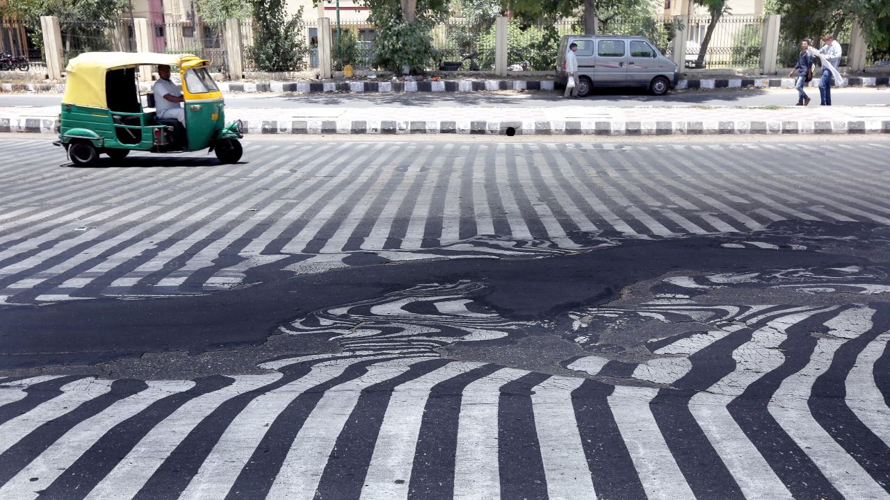 Road markings appear distorted as asphalt starts to melt because of the high temperature in New Delhi on May 27.