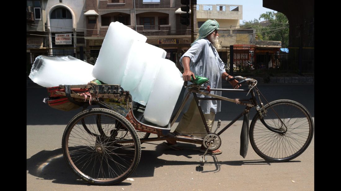A worker in Amritsar, India, uses a rickshaw to transport ice from a factory on Wednesday, May 27.