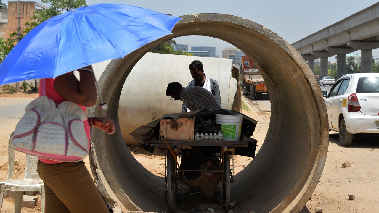 A roadside food vendor sets up his cart inside a concrete pipe in Gurgaon, on the outskirts of New Delhi, on May 27.