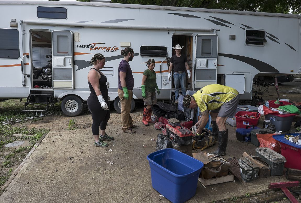 Butch Neuenschwander, right, looks for things to salvage from his RV, which was flooded in San Marcos, Texas, on Wednesday, May 27.