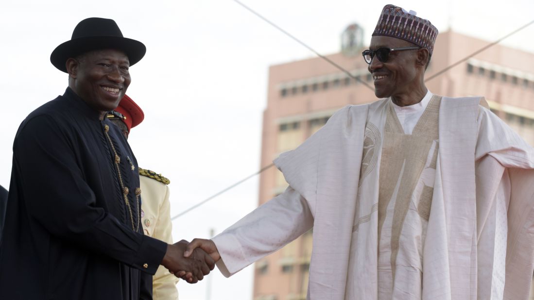 Former Nigerian President Goodluck Jonathan, left, shakes hands with Buhari after handing over power.