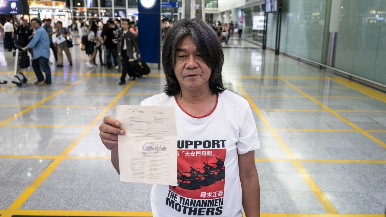 Hong Kong pro-democracy legislator Leung Kwok-Hung, also known as "Long Hair," holds up a notice from Malaysian officials forbidding him to enter the country on May 29, 2015 upon his return to Hong Kong.