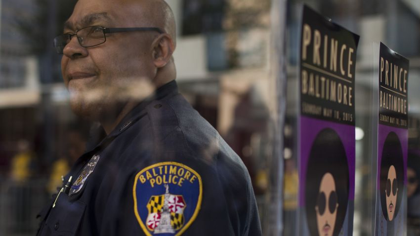 A police officer at a 'Rally 4 Peace' concert by Prince looks on in Baltimore, Maryland on May 10, 2015.