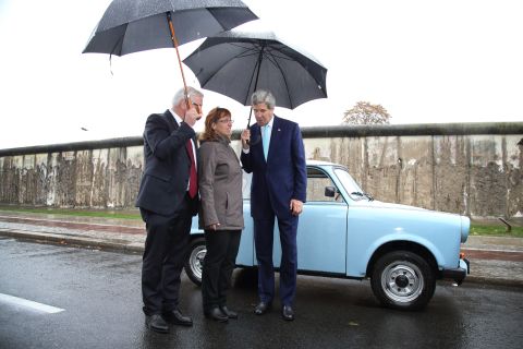 During a tour of the Berlin Wall memorial on October 22, 2014, in Berlin, Kerry and German Foreign Minister Frank-Walter Steinmeier, left, chat with Regina Webert-Lehmann, who in 1989 fled from communist East Germany in her Trabant car (pictured) to Hungary shortly before revolutions swept Eastern Europe. Kerry and Steinmeier met with students and walked along a still-standing portion of the wall that divided East and West Berlin and whose fall 25 years ago marked the end of the Cold War.  
