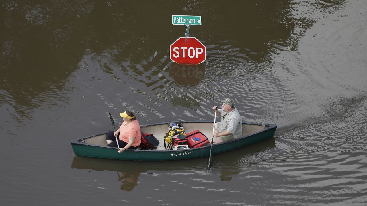 People canoe through floodwaters in Houston on Saturday, May 30.  Torrential rains have given Texas the wettest month on record, according to Texas A&M climatologists. In all, 37.3 trillion gallons of water have fallen over the state in May, the National Weather Service said.