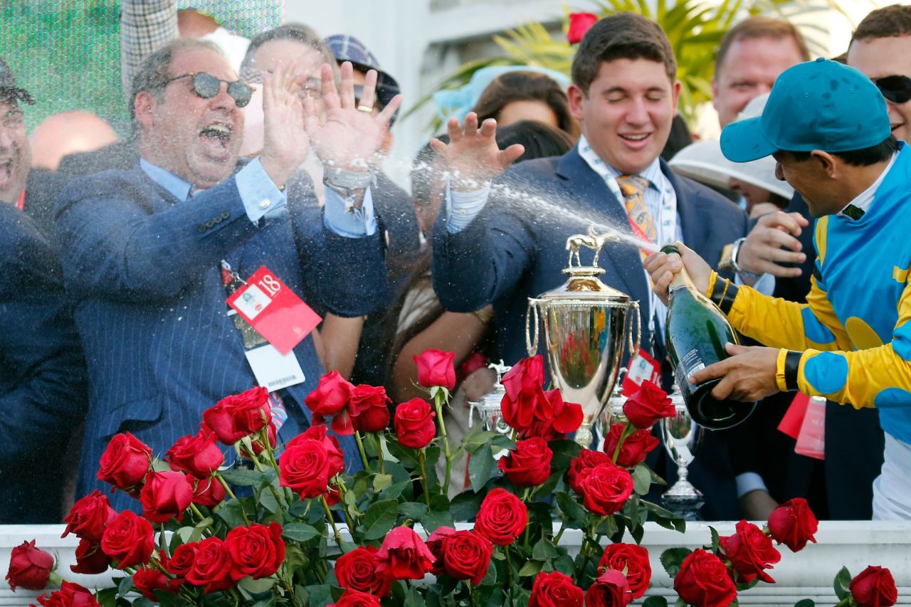 American Pharoah's owner, Ahmed Zayat, is sprayed with champagne in the Derby celebrations. Zayat made his money predominantly from selling his Egyptian brewing business to Heineken for an estimated $280 million.