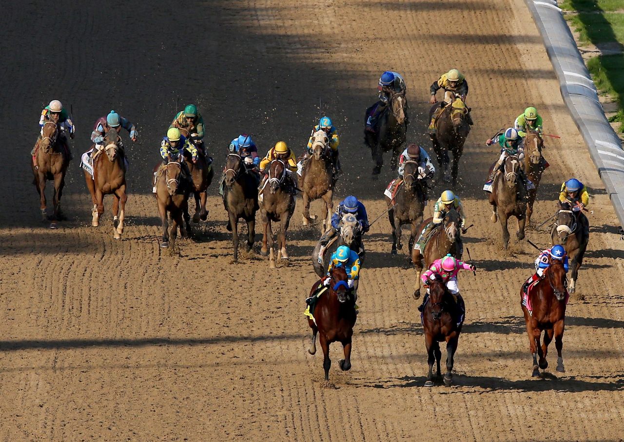 From left, American Pharoah, Firing Line and Dortmund lead the field as they head for the Derby finish line.