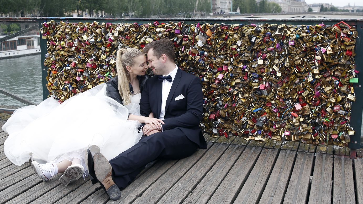 A married couple poses in front of the locks on Sunday, May 31.