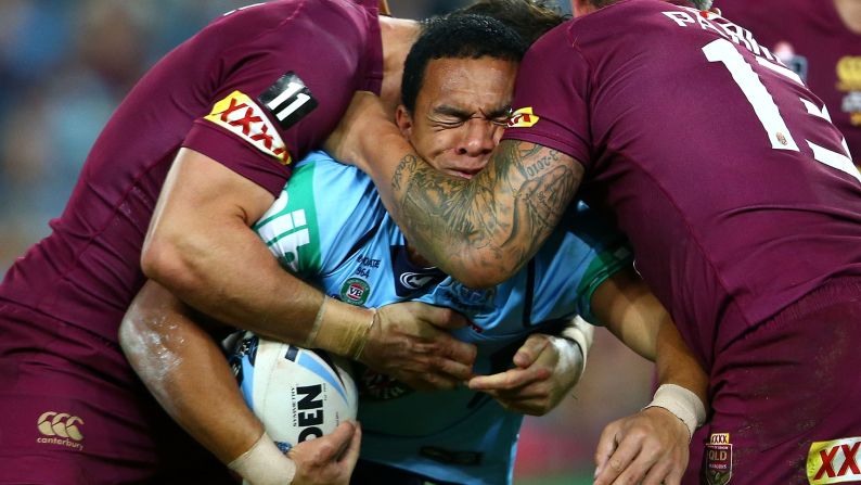Rugby player Will Hopoate, of the New South Wales Blues, is tackled by Queensland Maroons during Game 1 of the State of Origin series Wednesday, May 27, in Sydney. Queensland won 11-10 to take the early lead in the best-of-three series.