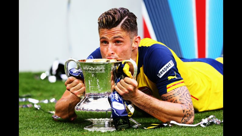 Arsenal striker Olivier Giroud celebrates with the FA Cup after his club defeated Aston Villa 4-0 in London on Saturday, May 30. With the victory, Arsenal has now won more FA Cups -- 12 -- than any club in English soccer.