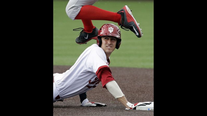 Indiana's Nick Ramos looks at the umpire as Radford infielder Danny Hrbek leaps over him during an NCAA tournament game Sunday, May 31, in Nashville, Tennessee. Ramos was the second out of a double play.