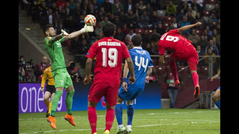 Denys Boyko, goalkeeper for Dnipro Dnipropetrovsk, reaches for a header by Sevilla's Carlos Bacca during the Europa League final Wednesday, May 27, in Warsaw, Poland. Bacca had two goals in the match as Sevilla won 3-2. It is the fourth time that the Spanish club has won the tournament, which used to be called the UEFA Cup.