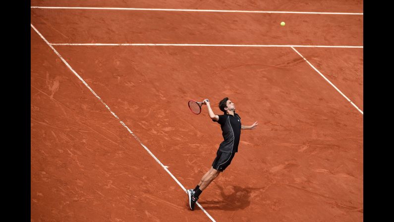 Gilles Simon serves to Nicolas Mahut during the third round of the French Open on Friday, May 29. In a battle of two Frenchmen, Simon advanced with a hard-fought five-set victory.