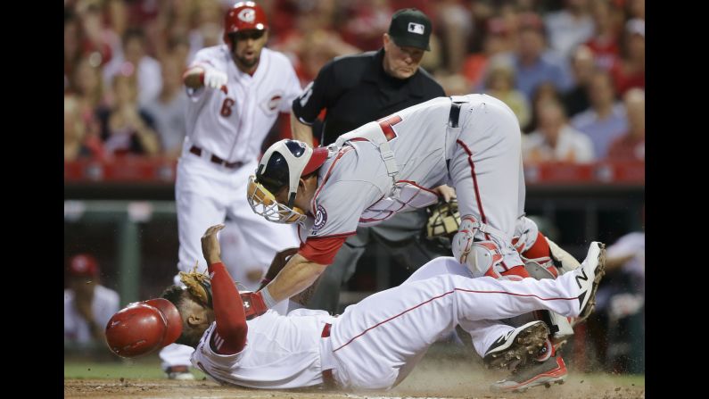 Cincinnati's Marlon Byrd, bottom, collides with Washington's Wilson Ramos during a game in Cincinnati on Friday, May 29.