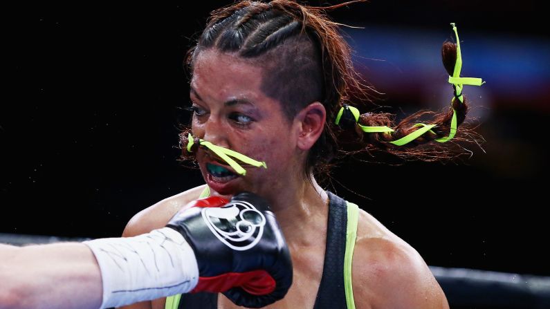 Noemi Bosques is punched by Heather Hardy during their junior featherweight bout in New York on Friday, May 29. Hardy won by split decision.