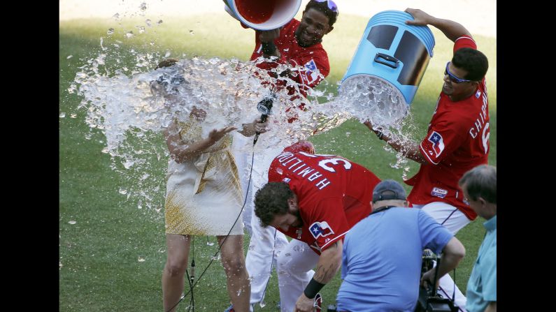 Texas outfielder Josh Hamilton and TV reporter Emily Jones are doused with Powerade by Hamilton's teammates Elvis Andrus, top, and Robinson Chirinos during a postgame interview on Sunday, May 31. Jones <a href="index.php?page=&url=https%3A%2F%2Ftwitter.com%2FEmilyJonesMcCoy%2Fstatus%2F605184671224242176" target="_blank" target="_blank">promised revenge</a> on Twitter. <a href="index.php?page=&url=http%3A%2F%2Fwww.cnn.com%2F2015%2F05%2F26%2Fsport%2Fgallery%2Fwhat-a-shot-sports-0525%2Findex.html" target="_blank">See 40 amazing sports photos from last week</a>
