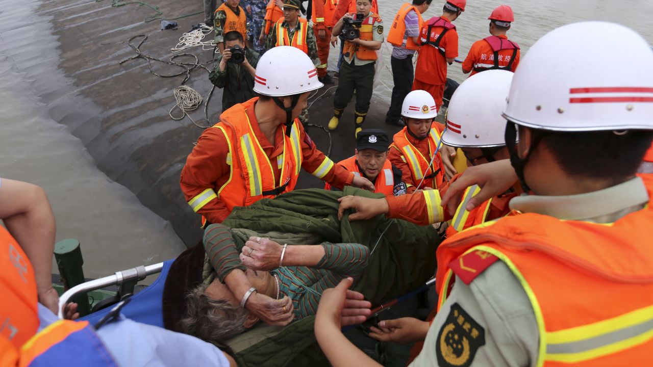 A survivor is carried onto the riverbank after being rescued on June 2.