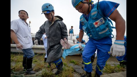 The body of a victim is brought onto the shore on June 2.