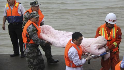 Rescue workers carry a survivor from the hull of the ship on June 2.