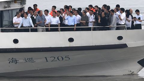 Chinese Premier Li Keqiang, center in blue shirt, and others view the rescue operation Tuesday on the Yangtze River.