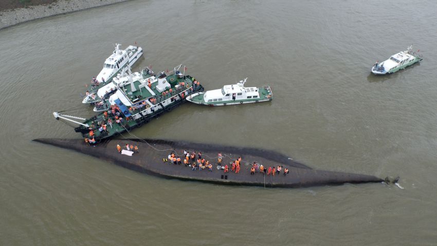 Rescuers search for survivors from the capsized ship.
