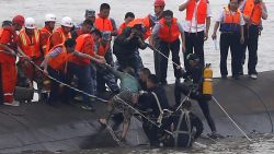 A survivor (C-green top) is rescued by divers from the Dongfangzhixing or 'Eastern Star' vessel which sank in the Yangtze river in Jianli, central China's Hubei province on June 2, 2015.