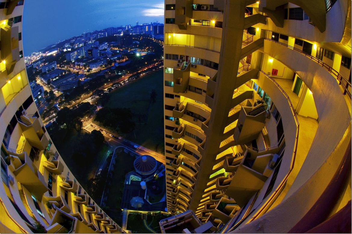 The skyline of Singapore reveals a range of styles and designs spanning different periods of the country's brief history. <br /><br />Perched on a hillside, the<a href="http://www.pearlbankapartments.com/singaporearchitect.htm" target="_blank" target="_blank"> Pearl bank apartments</a> were completed in 1976 and at the time, the tower was the tallest residential building in Singapore. Today, it has become somewhat of a historic landmark through its role as high-rise pioneer. <br /><br />The 38-storey, near-cylindrical tower houses 272 apartments with views over the city. The building was designed for the country's tropical climate in mind with the curved building orientated to avoid afternoon sun and slits incorporated between storeys by architect <a href="https://www.designsingapore.org/PDA_PUBLIC/gallery.aspx?sid=902" target="_blank" target="_blank">Tan Cheng Siong</a> to aid ventilation into an internal courtyard.
