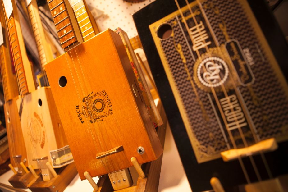 CNN's Mike Rowe gets a lesson in music history by learning how to make a guitar out of a cigar box. Pictured here are three- and four-string cigar box guitars built by Mike Snowden.