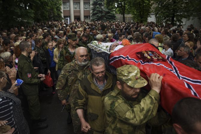 Pro-Russian rebels carry the coffin of <a href="index.php?page=&url=http%3A%2F%2Fwww.cnn.com%2F2015%2F05%2F24%2Feurope%2Fukraine-separatist-commander-killed%2Findex.html">prominent separatist commander Alexei Mozgovoi</a> during his funeral in Alchevsk, Ukraine, on Wednesday, May 27.