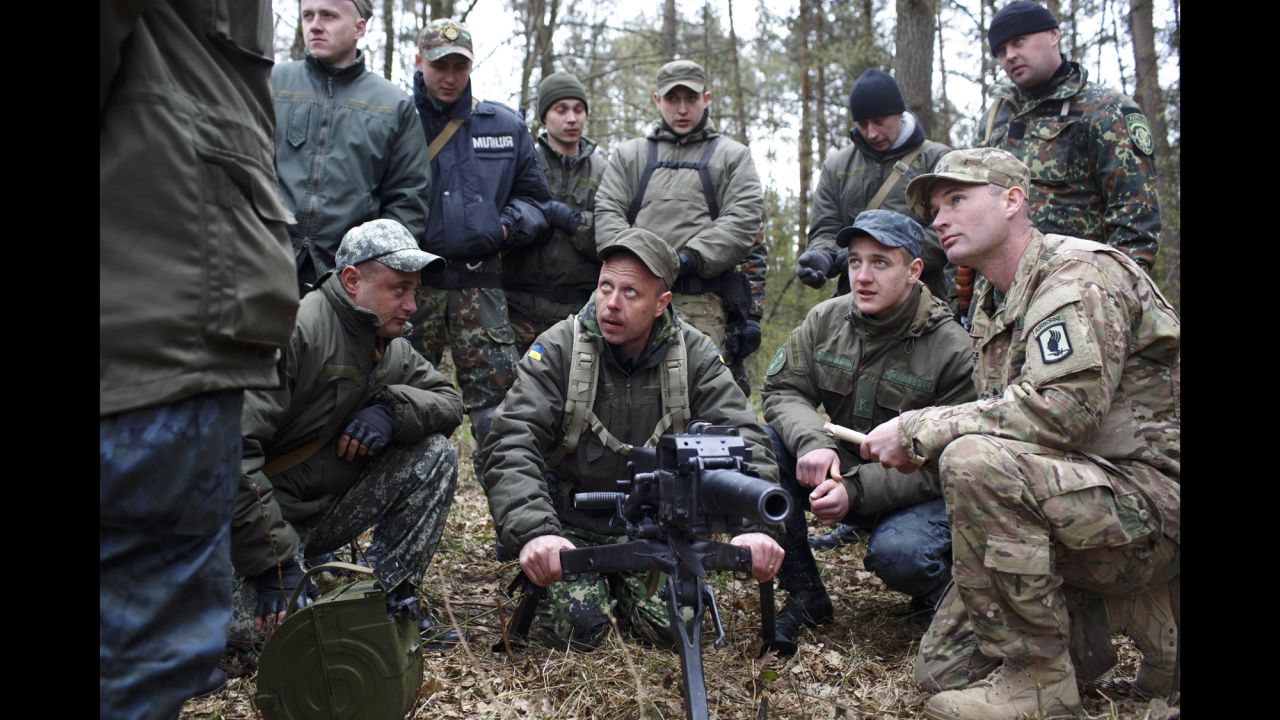 An American soldier, right, trains Ukrainian troops on Tuesday, April 21, near Yavoriv, Ukraine. Operation Fearless Guardian, a six-month training exercise, involves about 300 members of the American 173rd Airborne and about 900 Ukrainian National Guard troops.
