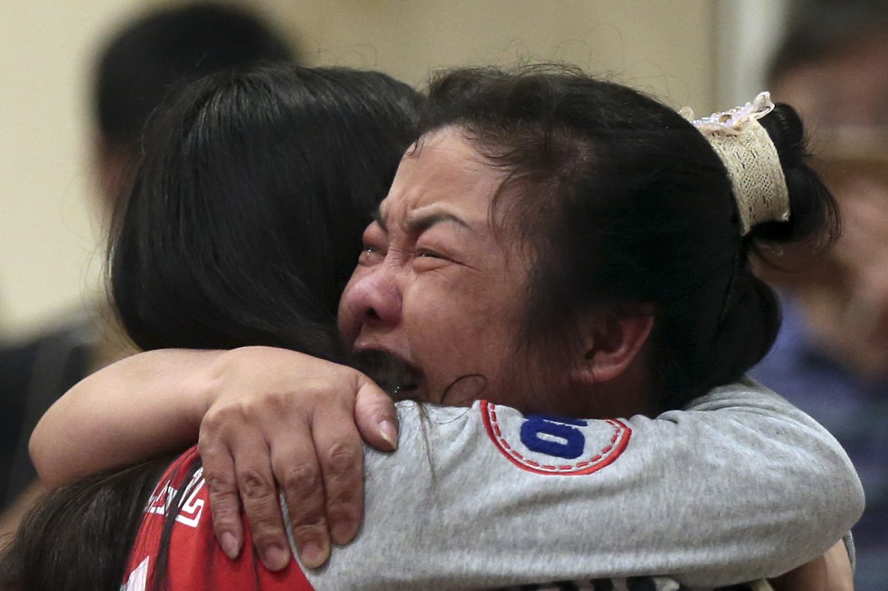 Two women comfort each other on Tuesday, June 2, at a Nanjing, China, hotel, where relatives of passengers trapped in the capsized cruise ship gathered.