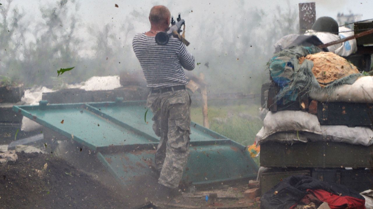 A Ukrainian serviceman fires a grenade launcher on the front lines near Donetsk on Saturday, May 30.