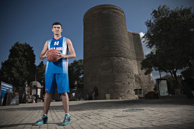 Azerbaijani basketball player Amil Hamzayev stands in front of the Maiden Tower in the heart of Baku's Old City.