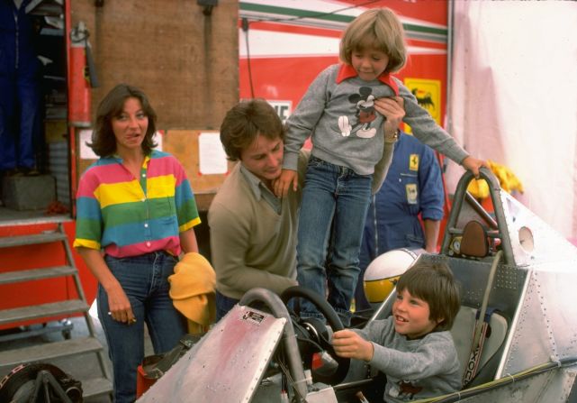 Gilles Villeneuve puts son Jacques at the controls of his Ferrari car whilst being pictured with his family in the Ferrari paddock during the 1979 F1 season.