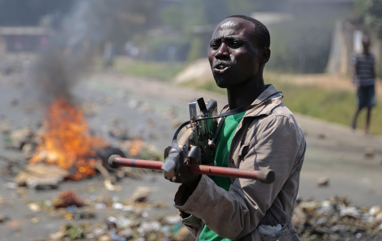 An opposition demonstrator points a mock gun at soldiers in Bujumbura, Burundi, on Wednesday, June 3. Animosity against Burundian President Pierre Nkurunziza boiled over in April when he expressed his intention to run for a third term. There have been demonstrations and a failed coup attempt.