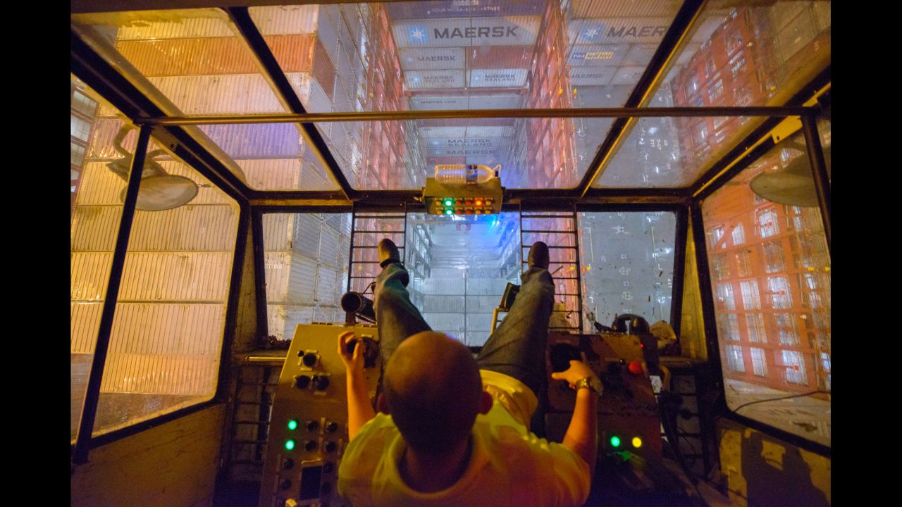 A Malaysian crane operator lowers a container into one of the Majestic's giant cargo bays.