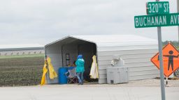 Workers at a checkpoint stand at an Iowa commercial poultry facility, reported to have been hit with a deadly strain of avian influenza which has forced poultry producers to kill off millions of birds in an attempt to stop the spread of the illness.