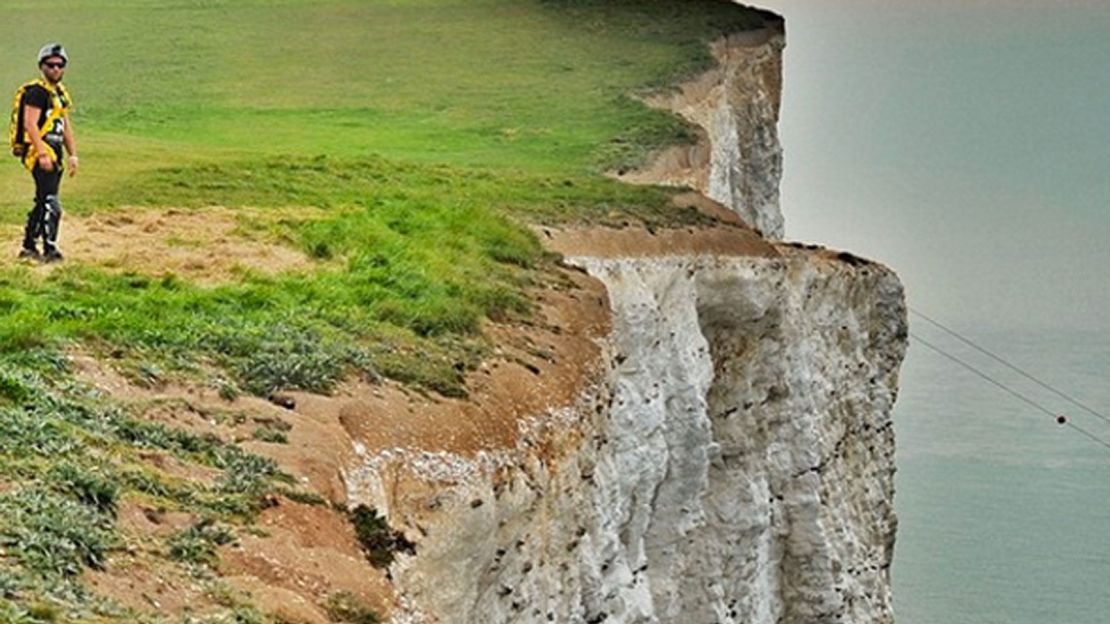Daring jumps, such as this one at Beachy Head in the UK, are a recurring theme in the video.