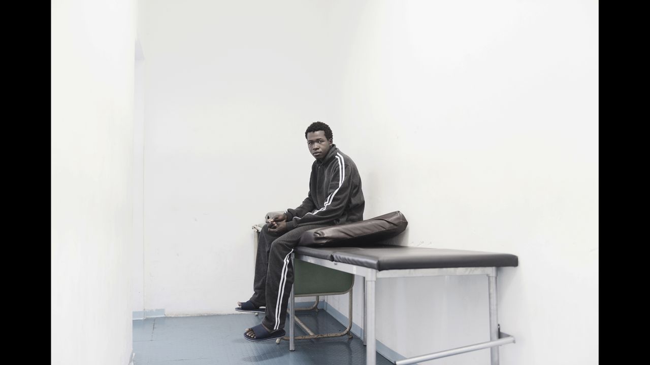 Amdi, 27, waits in the doctor's office, hoping to get some medication for a bad headache.