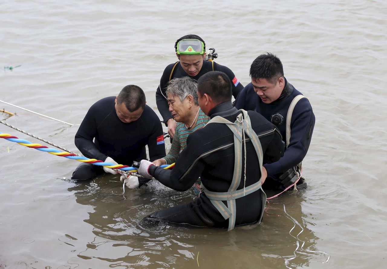 A woman is helped by divers after she was pulled from a sunken ship in Jianli, China, on Tuesday, June 2. The Eastern Star riverboat <a href="http://www.cnn.com/2015/06/02/china/gallery/china-yangtze-ship/index.html" target="_blank">capsized in stormy weather</a> with more than 450 people on board. Days later, many of them were still missing.