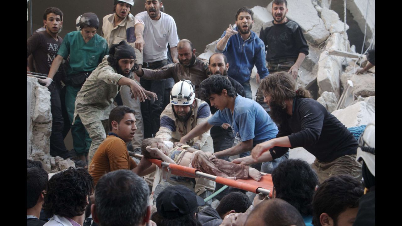 A child is carried on a stretcher following a barrel-bomb attack in Aleppo, Syria, on Saturday, May 30. The bombs were reportedly dropped by helicopters aligned with Syria's government forces, who have been battling rebels since an uprising in March 2011 <a href="http://www.cnn.com/2015/05/22/world/gallery/syria-civil-war-pictures/index.html" target="_blank">spiraled into civil war.</a>