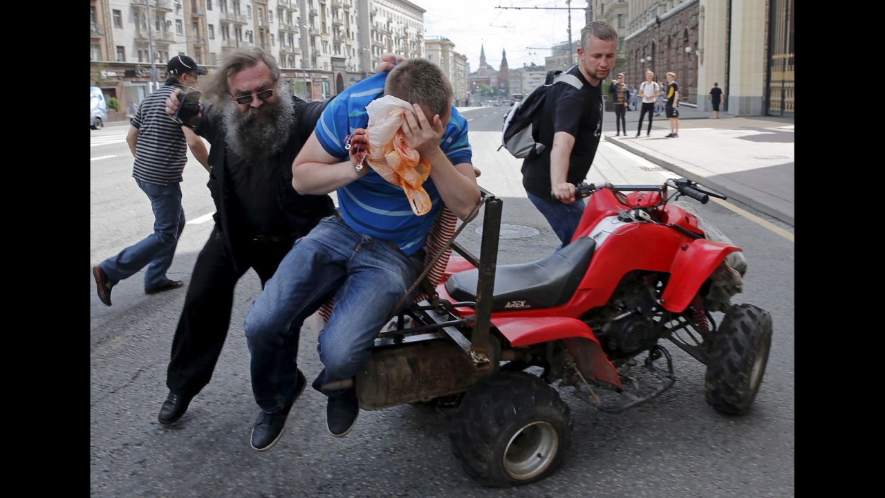 A gay rights activist is attacked by an anti-gay protester during an LGBT rally in Moscow on Saturday, May 30.