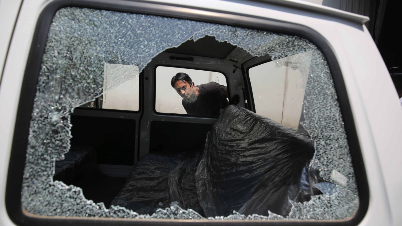 A man in Srinagar, India, looks inside a vehicle that was damaged in a grenade attack on Monday, June 1. One person was injured in the attack, which targeted a cell phone tower, police said.