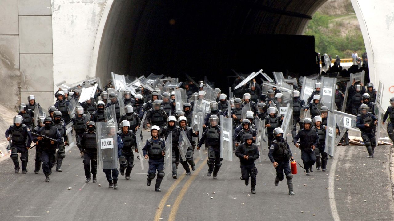 Police in riot gear chase after students of the Rural Normal School of Ayotzinapa after the students tried to reach the city of Chilpancingo, Mexico, to protest on Wednesday, June 3. In September, <a href="http://www.cnn.com/2014/11/21/americas/gallery/mexico-missing-student-protests/index.html" target="_blank">43 students from the school went missing</a> in the Mexican state of Guerrero. Four months later, Mexican Attorney General Jesus Murillo Karam said there is "legal certainty" that the students "were abducted, killed, burned and thrown into the San Juan River, in that order."